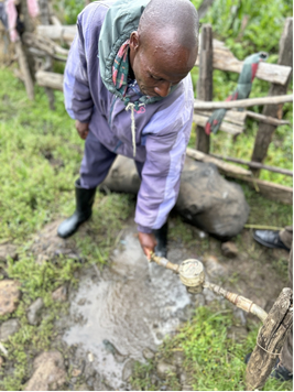 Man collecting water from a tap